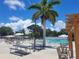 Inviting community pool with shaded seating and pergola at 3214 Pink Oak Ter, Sarasota, FL 34237
