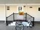 Front entry with decorative railing and tricycle at 3214 Pink Oak Ter, Sarasota, FL 34237