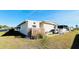 Tan mobile home with a landscaped yard at 3214 Pink Oak Ter, Sarasota, FL 34237