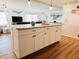 Kitchen island with granite countertop and white cabinets at 3214 Pink Oak Ter, Sarasota, FL 34237
