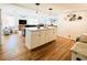 Open concept kitchen and living area with hardwood floors at 3214 Pink Oak Ter, Sarasota, FL 34237