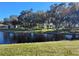 Picturesque gazebo by the lake, surrounded by lush landscaping at 3214 Pink Oak Ter, Sarasota, FL 34237