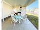Covered patio with table, chairs, and grill at 3214 Pink Oak Ter, Sarasota, FL 34237