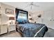 Bedroom with a king-size bed, ceiling fan, and white wicker furniture at 3219 Dawson St, Sarasota, FL 34239