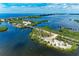 Aerial view of a bridge and waterways with lush vegetation at 362 Pine Run Dr, Osprey, FL 34229