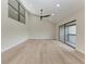 Spacious living room with vaulted ceilings, wood floors, and sliding doors to balcony at 362 Pine Run Dr, Osprey, FL 34229