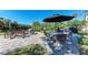 Community patio with table, chairs, and grill at 362 Pine Run Dr, Osprey, FL 34229