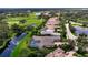 Aerial view of home with pool and lanai, situated in a golf course community at 4022 Mayors Ct, Sarasota, FL 34240