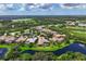 Aerial view of a home with a pool and lanai, nestled in a serene golf course community at 4022 Mayors Ct, Sarasota, FL 34240