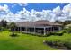 Stunning backyard oasis featuring a large pool, screened lanai, and lush landscaping at 4022 Mayors Ct, Sarasota, FL 34240