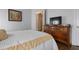 Bedroom with wood dresser and en-suite bathroom at 4022 Mayors Ct, Sarasota, FL 34240