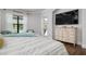 Primary bedroom with large TV and backyard access at 4022 Mayors Ct, Sarasota, FL 34240