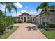 Elegant home with a paved driveway and lush landscaping at 4022 Mayors Ct, Sarasota, FL 34240