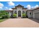 Inviting home exterior with a brick driveway and lush landscaping at 4022 Mayors Ct, Sarasota, FL 34240