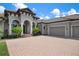 Two-story house with a three-car garage and manicured lawn at 4022 Mayors Ct, Sarasota, FL 34240