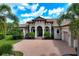 Luxury home exterior, landscaped yard, brick driveway at 4022 Mayors Ct, Sarasota, FL 34240
