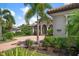 Landscaped front yard with palm trees and driveway at 4022 Mayors Ct, Sarasota, FL 34240