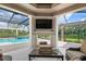 Covered patio overlooks a refreshing pool with a fireplace at 4022 Mayors Ct, Sarasota, FL 34240