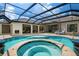 Luxury pool and spa with a covered lanai and beautiful landscaping at 4022 Mayors Ct, Sarasota, FL 34240