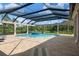 Resort-style pool and spa with a screened enclosure and lush landscaping at 4022 Mayors Ct, Sarasota, FL 34240