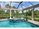 Screened pool and spa with a tranquil outdoor seating area at 4022 Mayors Ct, Sarasota, FL 34240