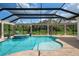 Relaxing pool and spa area with a covered lanai and tranquil view at 4022 Mayors Ct, Sarasota, FL 34240