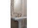 Charming powder room with pedestal sink and ornate mirror at 4022 Mayors Ct, Sarasota, FL 34240