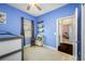 Blue bedroom with bunk bed, play area, and access to a hallway at 4138 Deep Creek Ter, Parrish, FL 34219