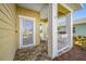 Front porch with white columns, tiled flooring, and a white adirondack chair at 4138 Deep Creek Ter, Parrish, FL 34219