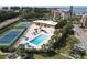 Community pool and tennis courts with water views at 4500 Gulf Of Mexico Dr # 305, Longboat Key, FL 34228