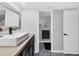 Modern bathroom with floating sink, shiplap walls, and patterned floor tiles at 4500 Gulf Of Mexico Dr # 305, Longboat Key, FL 34228