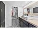 Stylish bathroom with a floating sink, shiplap walls, and walk-in closet at 4500 Gulf Of Mexico Dr # 305, Longboat Key, FL 34228