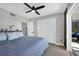 Bedroom with king-size bed, balcony access, and ceiling fan at 4500 Gulf Of Mexico Dr # 305, Longboat Key, FL 34228