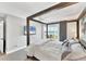 Bright bedroom with water views, a large bed, and sliding glass doors to balcony at 4500 Gulf Of Mexico Dr # 305, Longboat Key, FL 34228
