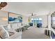 Living room with water views, comfy seating and fireplace at 4500 Gulf Of Mexico Dr # 305, Longboat Key, FL 34228