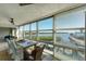 Sunroom with water views and dining table at 4500 Gulf Of Mexico Dr # 305, Longboat Key, FL 34228