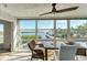 Bright sunroom with water views and dining table at 4500 Gulf Of Mexico Dr # 305, Longboat Key, FL 34228