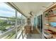 Sunroom with water views, dining table, and wicker chairs at 4500 Gulf Of Mexico Dr # 305, Longboat Key, FL 34228