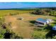 Wide angle aerial shot of the horse farm showing pasture and surrounding area at 4939 Myakka Valley Trl, Sarasota, FL 34241