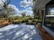 Inviting back porch with ample seating and a picturesque view of the lush garden and open field at 4939 Myakka Valley Trl, Sarasota, FL 34241