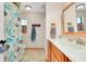 Bathroom featuring tiled floors, wood cabinets, a sink and shower with curtain at 4939 Myakka Valley Trl, Sarasota, FL 34241