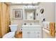 Quaint bathroom featuring a white vanity, and a decorative mirror and fixtures at 4939 Myakka Valley Trl, Sarasota, FL 34241