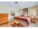 Comfortable bedroom with wood floors, horse themed decor, and natural lighting at 4939 Myakka Valley Trl, Sarasota, FL 34241