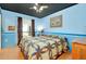 Stylish bedroom featuring light blue walls, a dark ceiling and a decorative quilt at 4939 Myakka Valley Trl, Sarasota, FL 34241