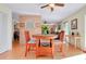 Dining area that connects to living room, ceiling fan, and hardwood floors at 4939 Myakka Valley Trl, Sarasota, FL 34241