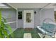 Welcoming entryway with a decorative glass door, cozy bench, and a charming vintage wagon wheel detail at 4939 Myakka Valley Trl, Sarasota, FL 34241