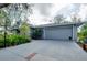 Charming one-story home features a gray exterior with an attached garage and beautiful landscaping at 4939 Myakka Valley Trl, Sarasota, FL 34241