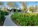 Home featuring mature landscaping and a walkway to the screened porch at 4939 Myakka Valley Trl, Sarasota, FL 34241