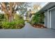 Landscaped front yard with a winding walkway and mature trees at 4939 Myakka Valley Trl, Sarasota, FL 34241