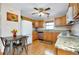 Bright kitchen with wood cabinets, granite countertops, stainless steel appliances, and a charming eat-in area at 4939 Myakka Valley Trl, Sarasota, FL 34241
